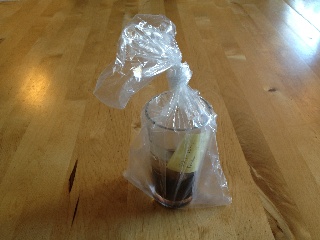 The glass where the tooth was left in Coca-Cola for sixteen months